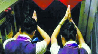 Photo of Air Hostesses Worshipping “On Time” Shrine Goes Viral