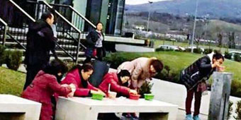 Chinese Aunties Pop a Squat, Chow Down on Instant Noodles outside Gucci 