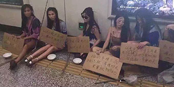 Shanghai Auto Show Models Dress as Beggars as Part of Protest 