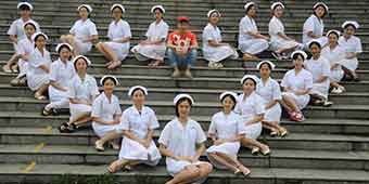 Female Nursing Students Form Heart Around Only Male Classmate in Viral Graduation Photo 
